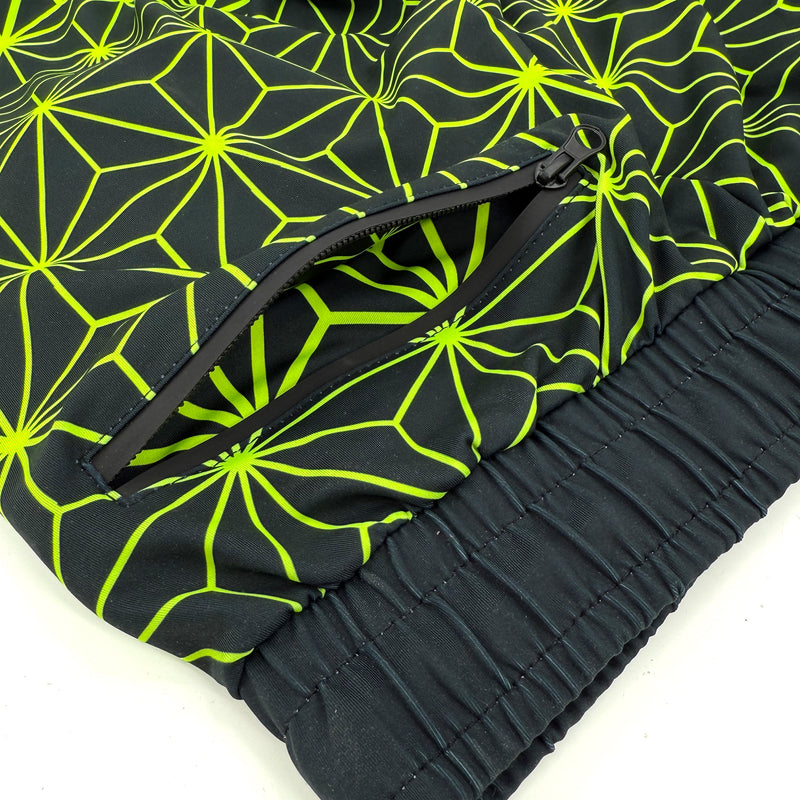 Asanoha yellow UV joggers by First Earth – rave-ready pants with glowing Asanoha sacred geometry, soft breathable polyester, zip pockets, and comfortable elastic waistband
