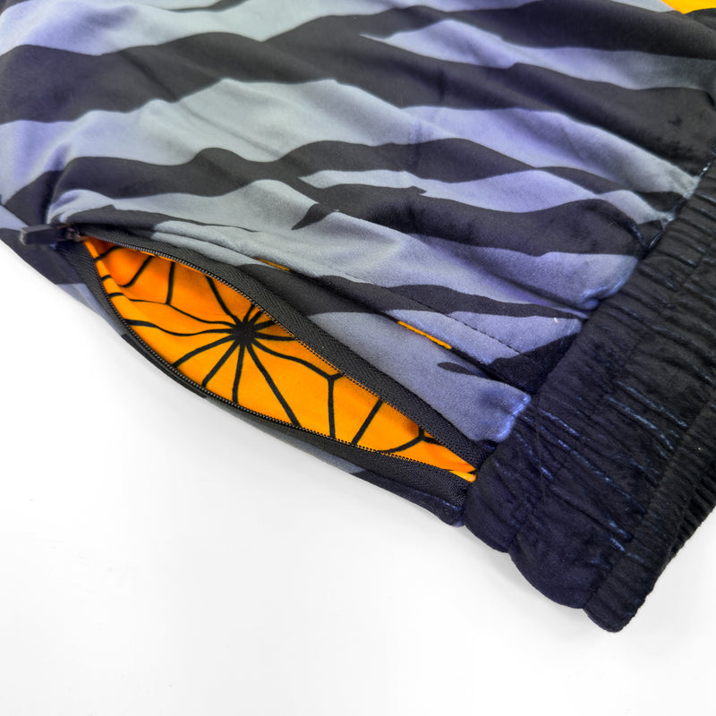 Close up of First Earth Sacred Stripes UV velvet harem joggers hip zipper pocket