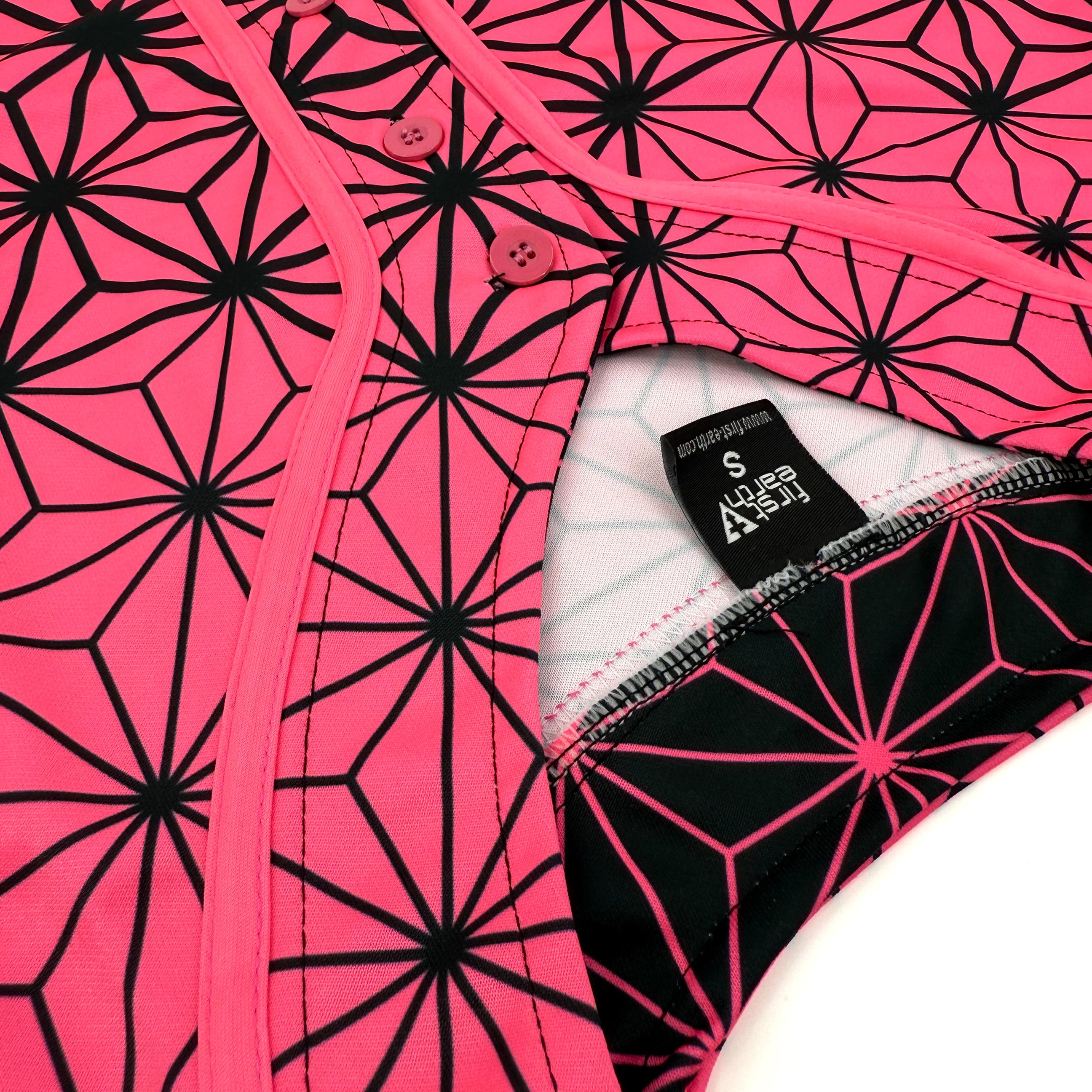 Asanoha pink UV crop baseball jersey by First Earth – cropped rave tee that glows under blacklight, featuring delicate Asanoha geometry on breathable fabric 