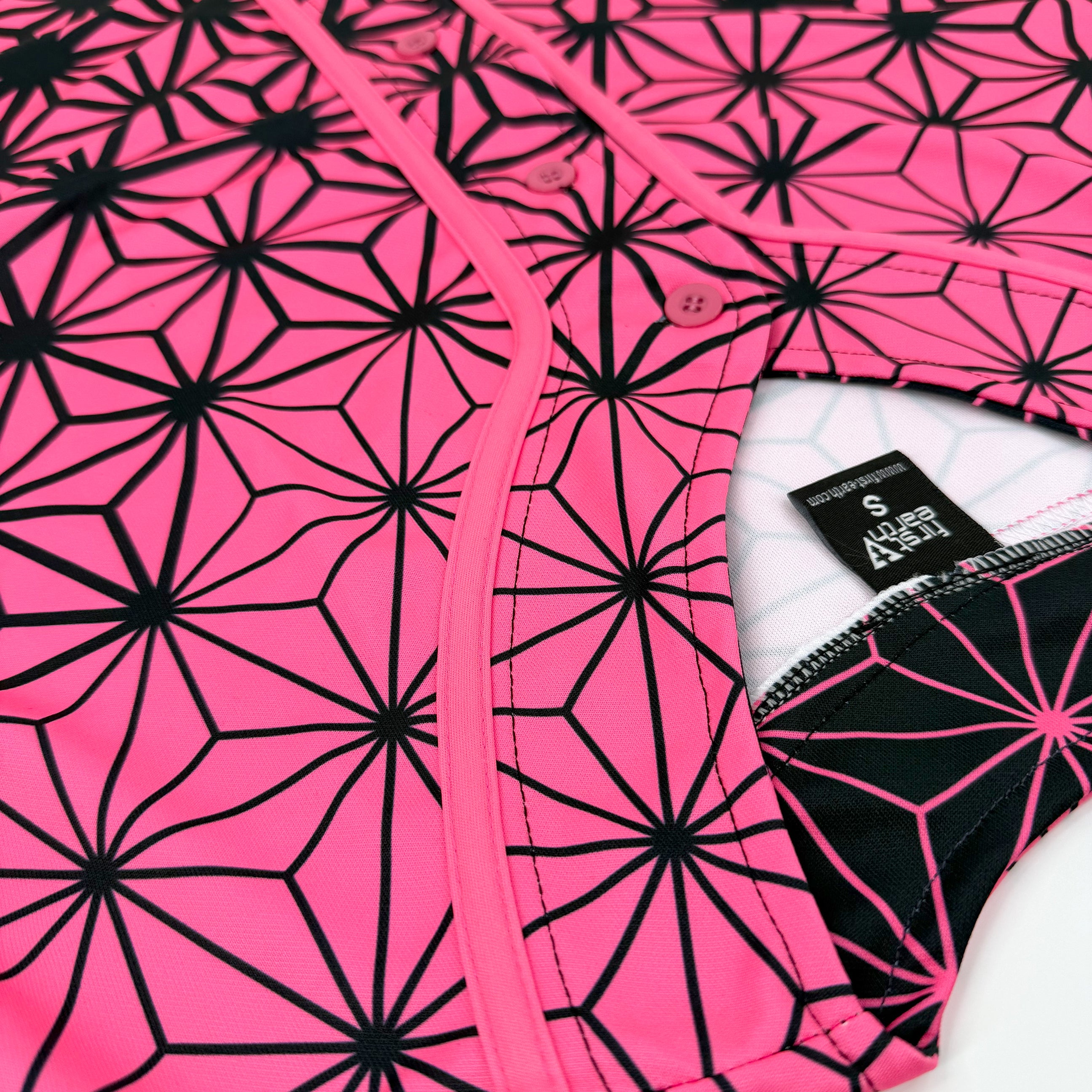 Asanoha pink UV baseball jersey by First Earth – oversized rave jersey glowing under blacklight, adorned with sacred Asanoha geometric design 