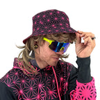 Asanoha pink UV bucket hat by First Earth – glowing sacred geometry rave hat that shines under blacklight, lightweight and perfectly portable for festival adventure 