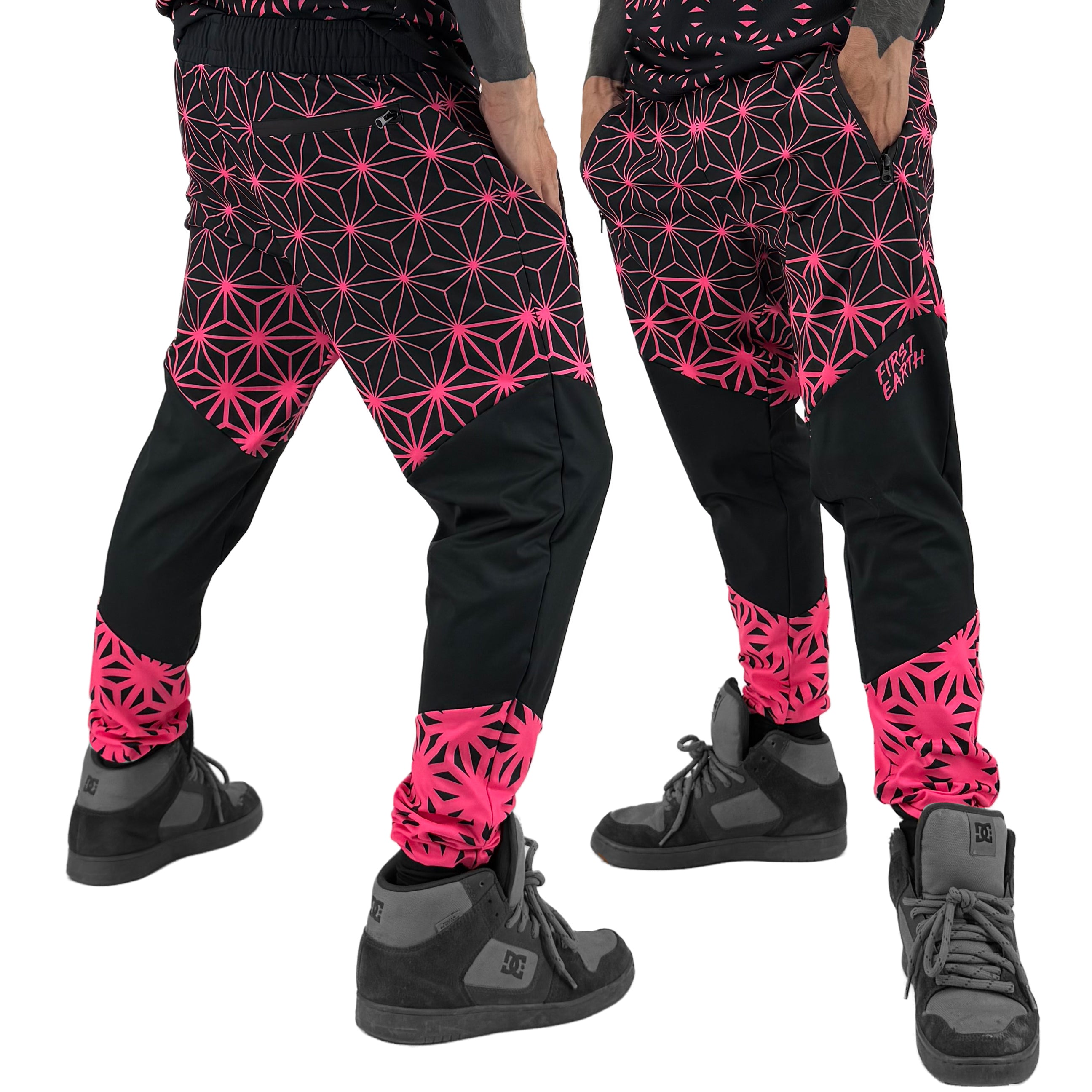 Asanoha pink UV joggers by First Earth – festival-friendly pants with glowing sacred geometry design, breathable fabric, zip pockets, and relaxed fit waistband 