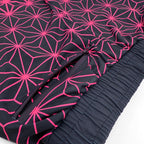 Asanoha pink UV joggers by First Earth – festival-friendly pants with glowing sacred geometry design, breathable fabric, zip pockets, and relaxed fit waistband 