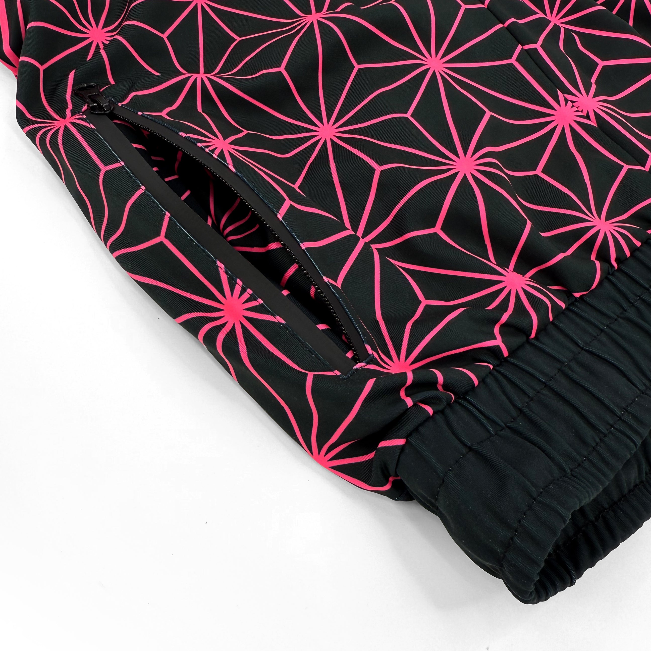 Asanoha pink UV joggers by First Earth – festival-friendly pants with glowing sacred geometry design, breathable fabric, zip pockets, and relaxed fit waistband 