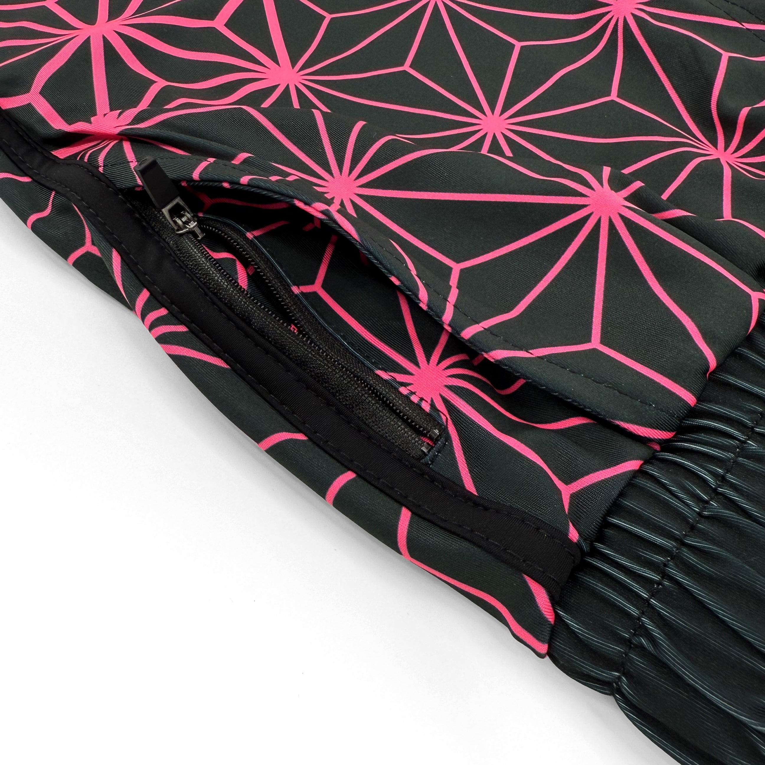 Asanoha pink UV shorts by First Earth – rave-ready shorts with glowing sacred geometry design under blacklight, soft breathable fabric, zip and velcro pockets for hands-free flow