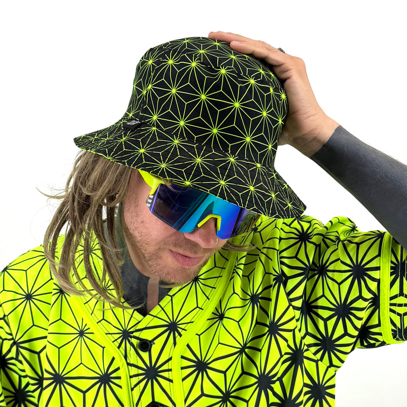 Asanoha yellow UV bucket hat by First Earth – rave-ready hat with glowing sacred geometry pattern, lightweight and breathable for all-night festival wear 