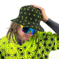 Asanoha yellow UV bucket hat by First Earth – rave-ready hat with glowing sacred geometry pattern, lightweight and breathable for all-night festival wear 