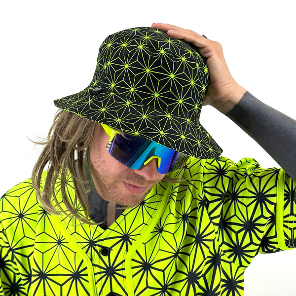 Asanoha yellow UV bucket hat by First Earth – rave-ready hat with glowing sacred geometry pattern, lightweight and breathable for all-night festival wear 