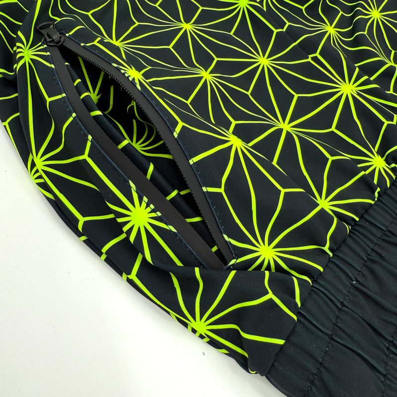 Asanoha yellow UV joggers by First Earth – rave-ready pants with glowing Asanoha sacred geometry, soft breathable polyester, zip pockets, and comfortable elastic waistband 