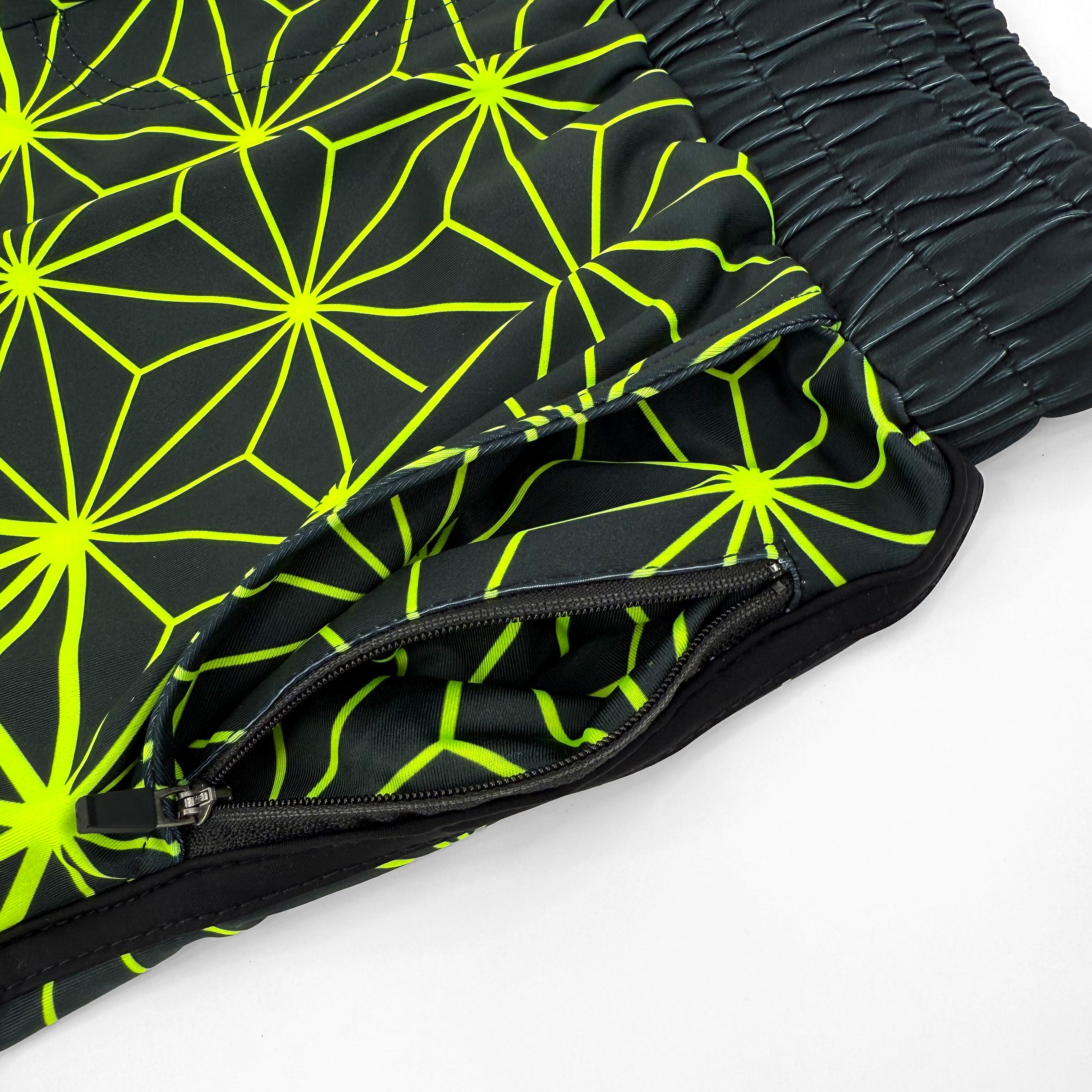 Asanoha yellow UV shorts by First Earth – rave-ready shorts featuring glowing sacred geometry design under blacklight, lightweight and breathable with practical pockets