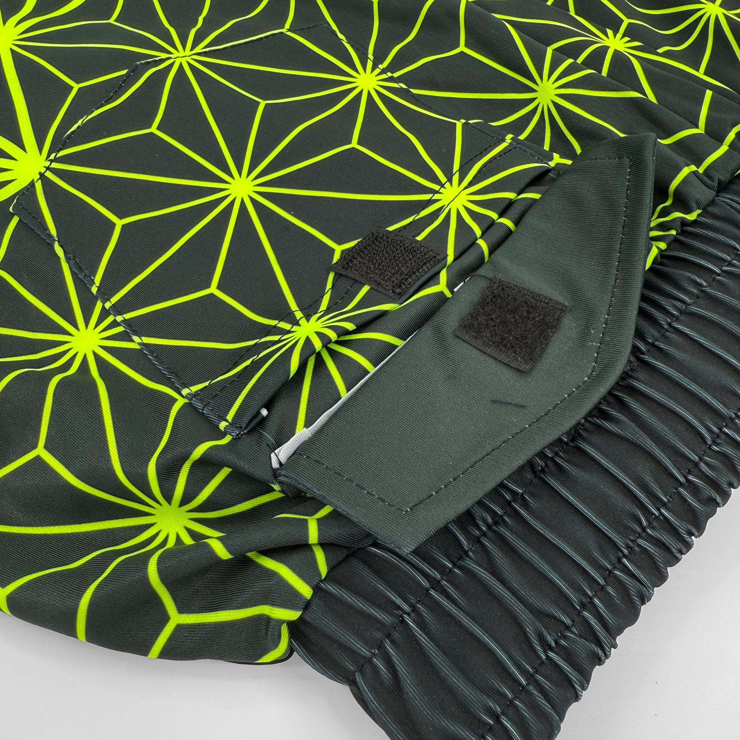 Asanoha yellow UV shorts by First Earth – rave-ready shorts featuring glowing sacred geometry design under blacklight, lightweight and breathable with practical pockets