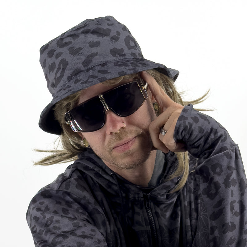 First Earth Midnight Cheetah velvet bucket hat on model, angled view with dark grey black leopard print
