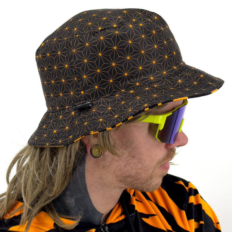 First Earth Sacred Stripes UV velvet bucket hat reverse side showing orange black sacred geometry asanoha pattern