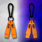 Neon orange First Earth Flow Star carabiner shown in daylight and glowing under blacklight