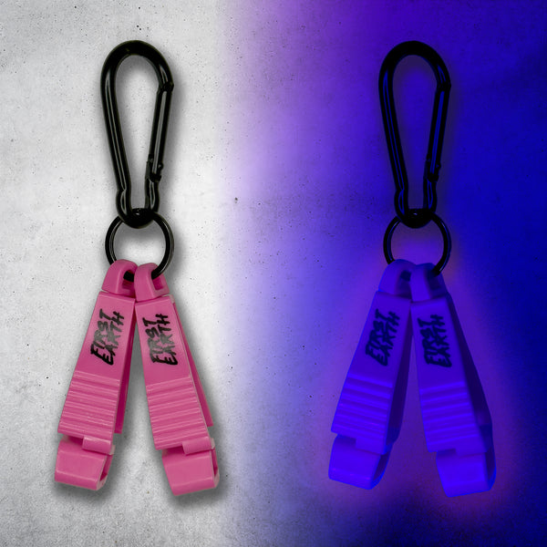 Pink First Earth Flow Star carabiner shown in daylight and glowing violet under blacklight