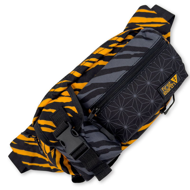 First Earth Sacred Stripes crossbody bag front with strap, buckle, logo patch, and geometric pocket