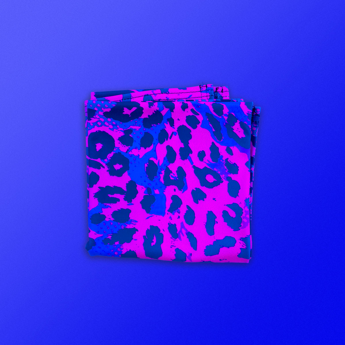 Neon Cheetah UV square bandana under blacklight