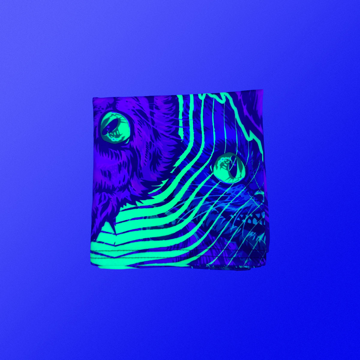 Cheshire Cat UV-reactive festival bandana glowing under blacklight