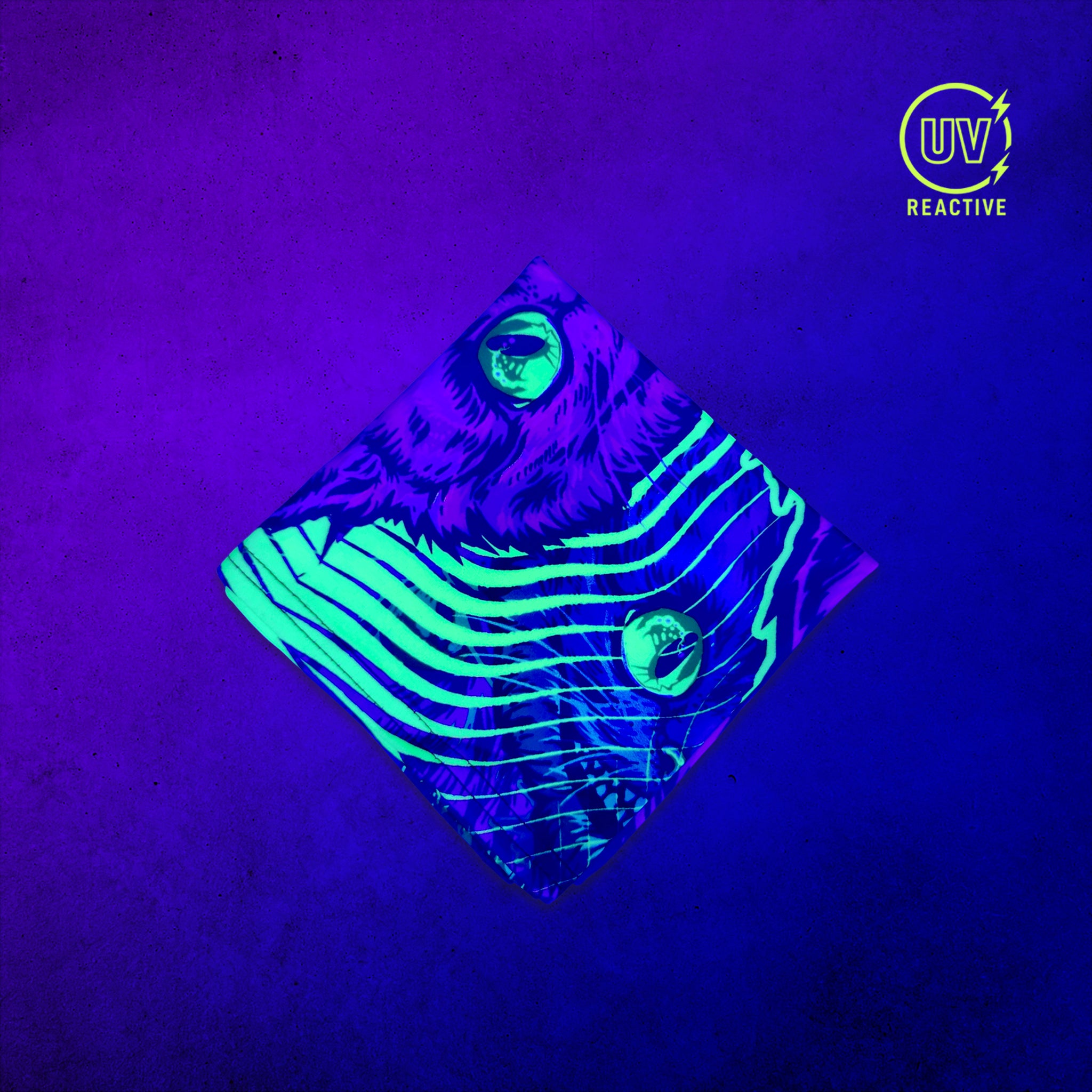 Cheshire Cat - UV Glow - Bandana glowing under black light, showing the UV-reactive colors and complete printed design