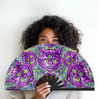 Cheshire Cat UV glow hand fan by First Earth – collapsible rave fan with glowing Cheshire Cat design, bamboo ribs, and vibrant polyester fabric for festival breeze