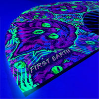 Cheshire Cat UV glow hand fan by First Earth – collapsible rave fan with glowing Cheshire Cat design, bamboo ribs, and vibrant polyester fabric for festival breeze