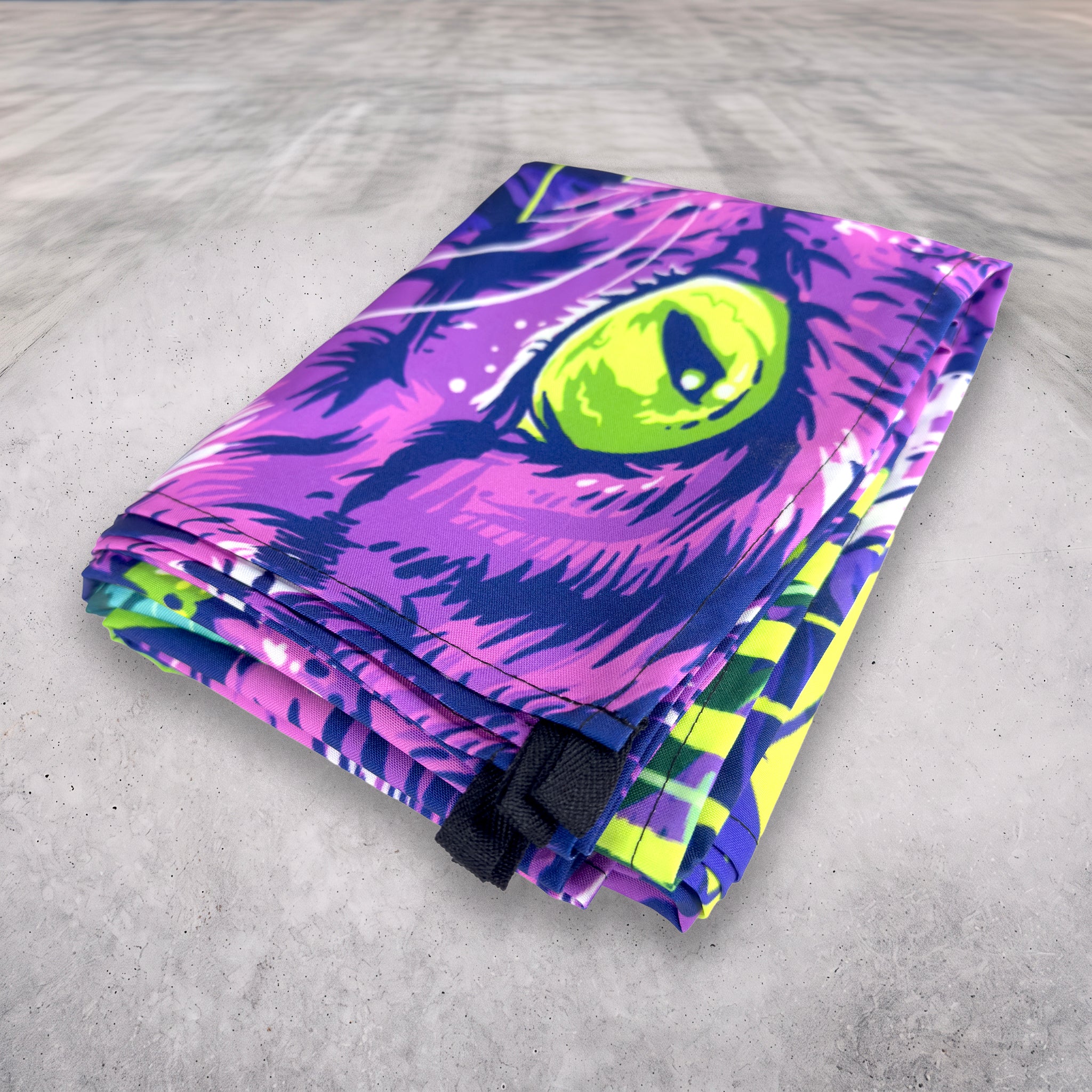 Cheshire Dreams UV tapestry by First Earth folded, showing the sewn in loops for hanging