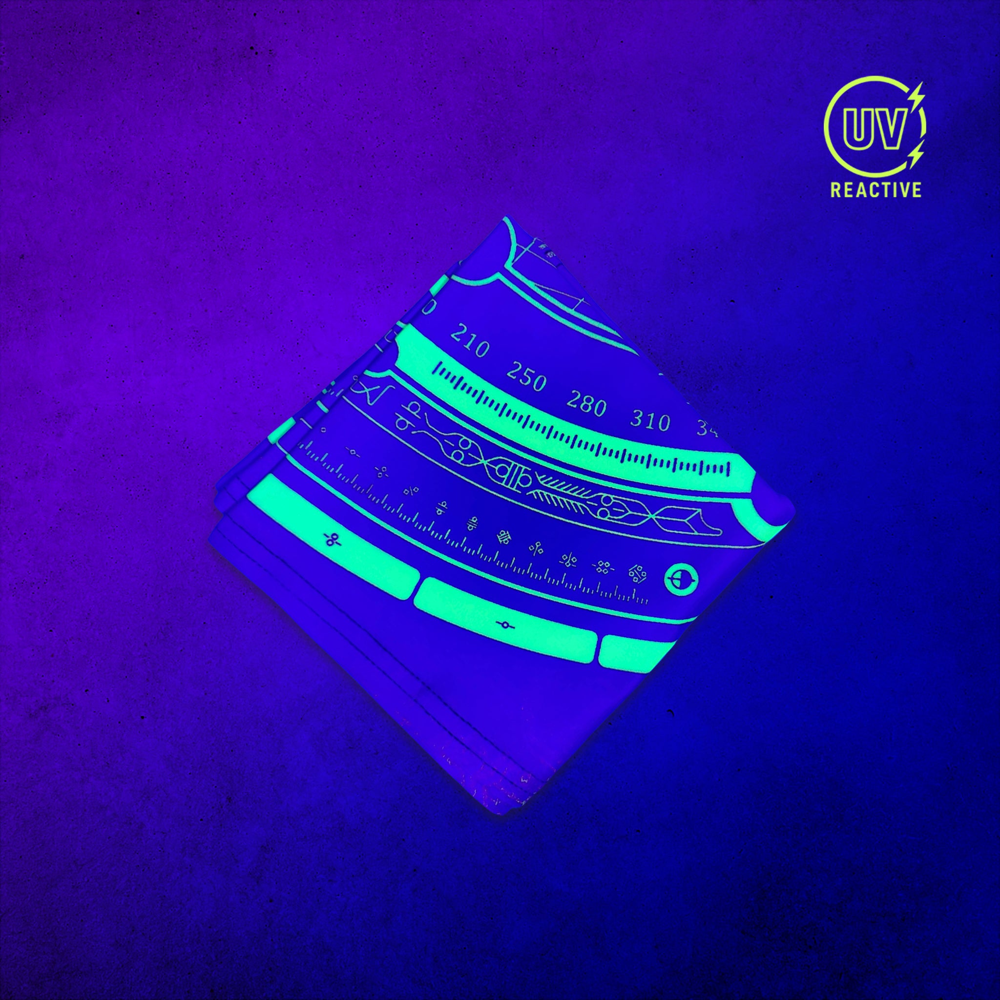 Celestial Compass - UV Glow - Bandana glowing under black light, showing the UV-reactive colors and complete printed design