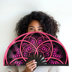 Flower of Life UV glow pink hand fan  by First Earth – portable rave fan with glowing sacred geometry print, bamboo ribs, and vibrant polyester fabric for festival flair