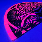 Flower of Life UV glow pink hand fan  by First Earth – portable rave fan with glowing sacred geometry print, bamboo ribs, and vibrant polyester fabric for festival flair