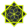 Front view of the First Earth Flow Star in the Flower of Life Midnight design, showing a neon yellow sacred geometry pattern stitched onto black fabric in an eight-point star shape.