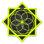 Front view of the First Earth Flow Star in the Flower of Life Midnight design, showing a neon yellow sacred geometry pattern stitched onto black fabric in an eight-point star shape.