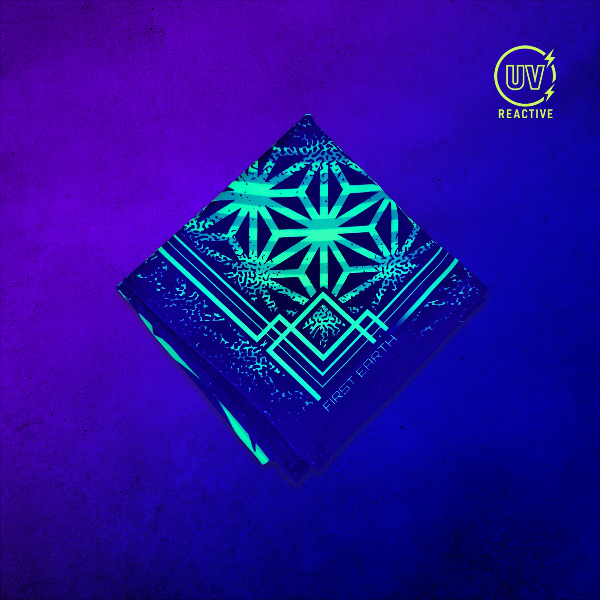 Flower of Life Green UV-reactive bandana by First Earth glowing under black light, showing the complete printed design