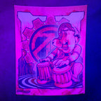 Ganesh UV tapestry by First Earth glowing under UV black light