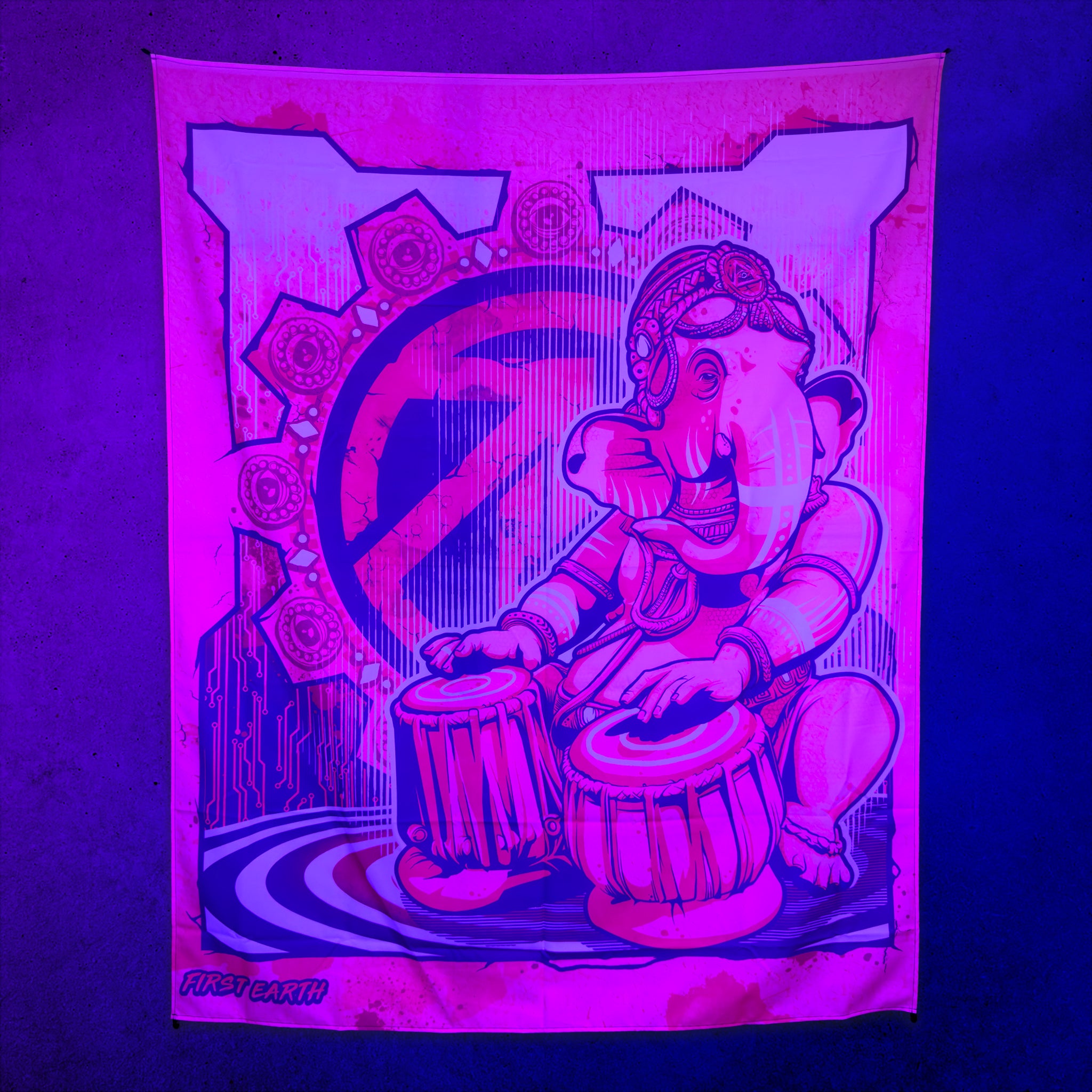 Ganesh UV tapestry by First Earth glowing under UV black light