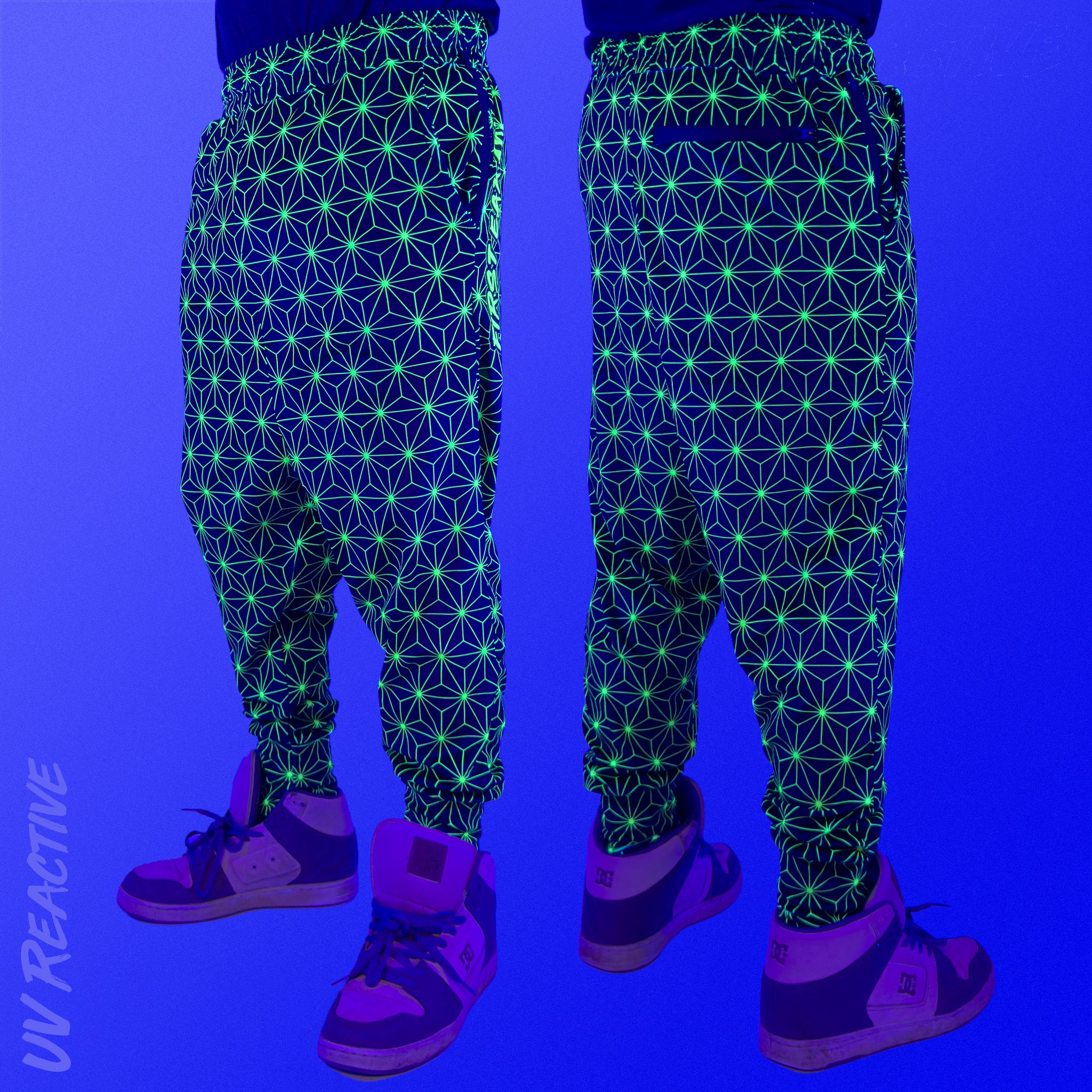 First Earth Asanoha Yellow velvet harem joggers under UV blacklight on model showing glowing yellow geometric asanoha pattern