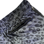 Close up of First Earth Midnight Cheetah velvet harem joggers back zipper pocket