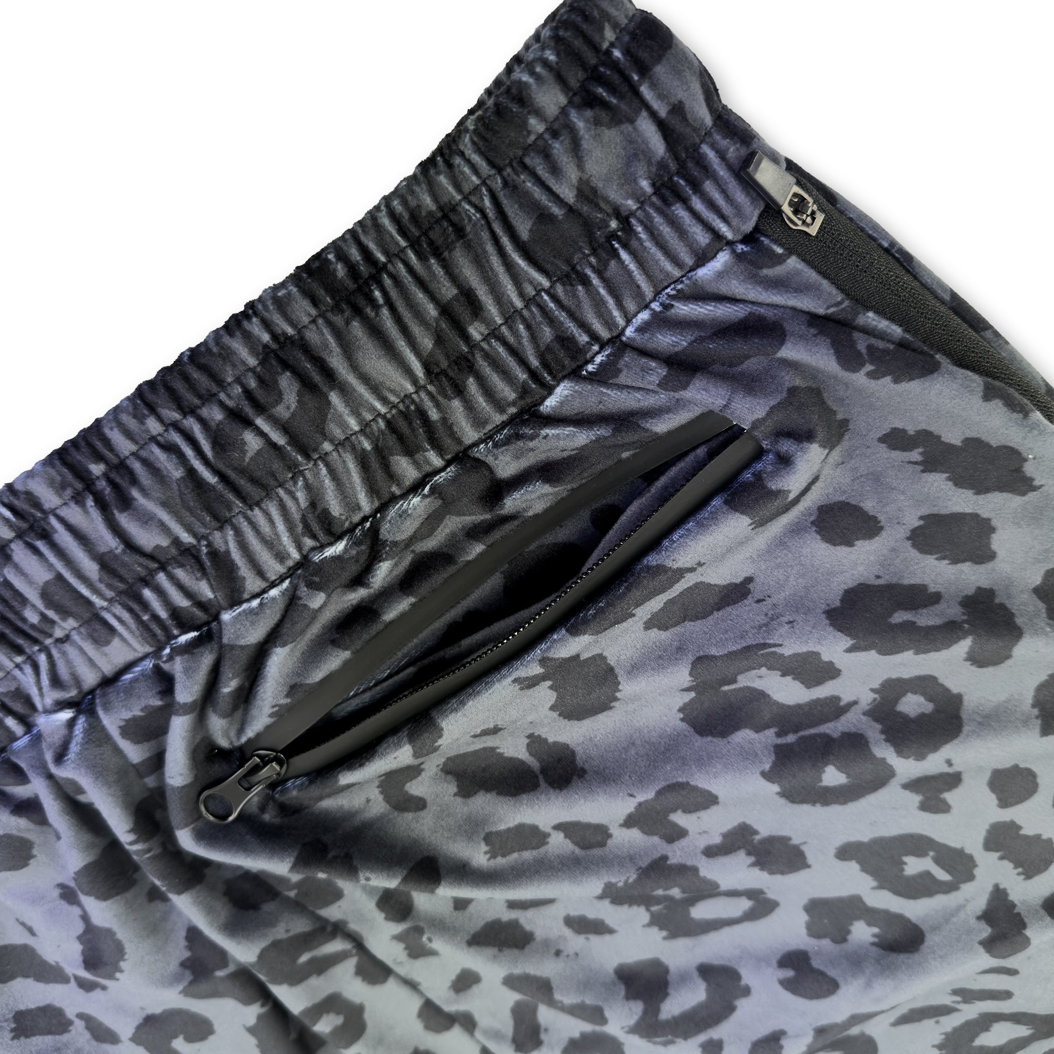 Close up of First Earth Midnight Cheetah velvet harem joggers back zipper pocket