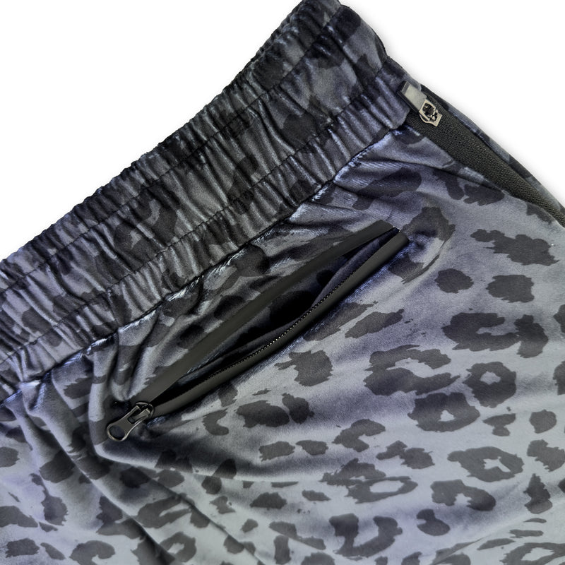 Close up of First Earth Midnight Cheetah velvet harem joggers back zipper pocket