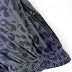 Close up of First Earth Midnight Cheetah velvet harem joggers hip zipper pocket