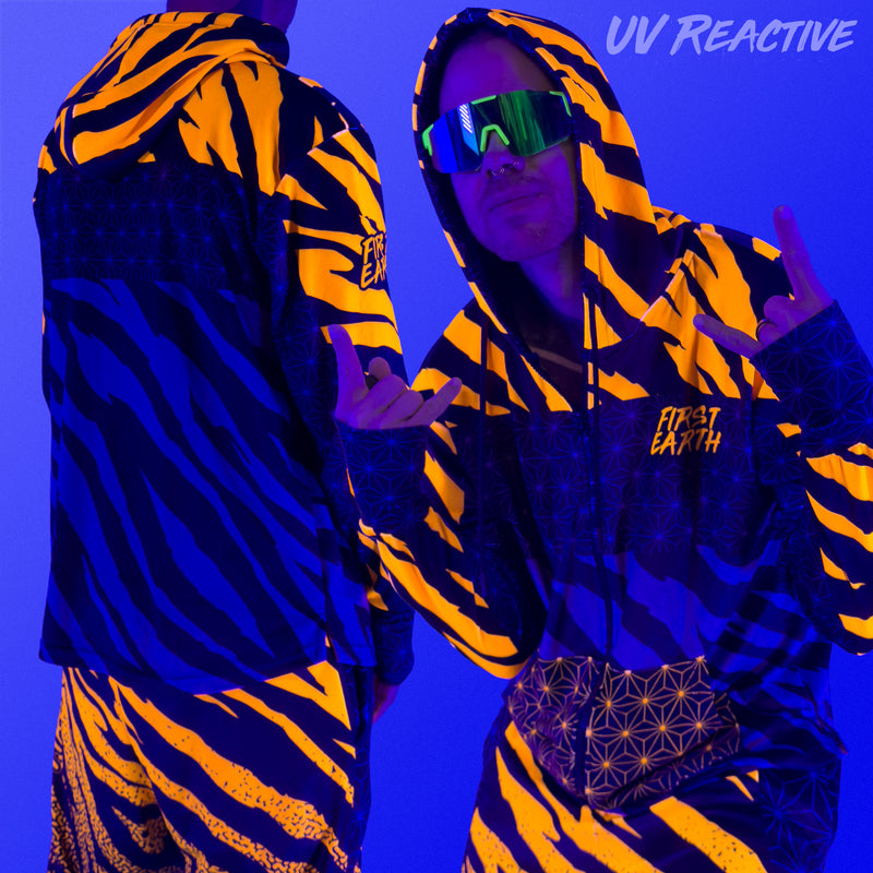First Earth Sacred Stripes UV zip hoodie under blacklight on model showing glowing orange tiger stripe design front and back