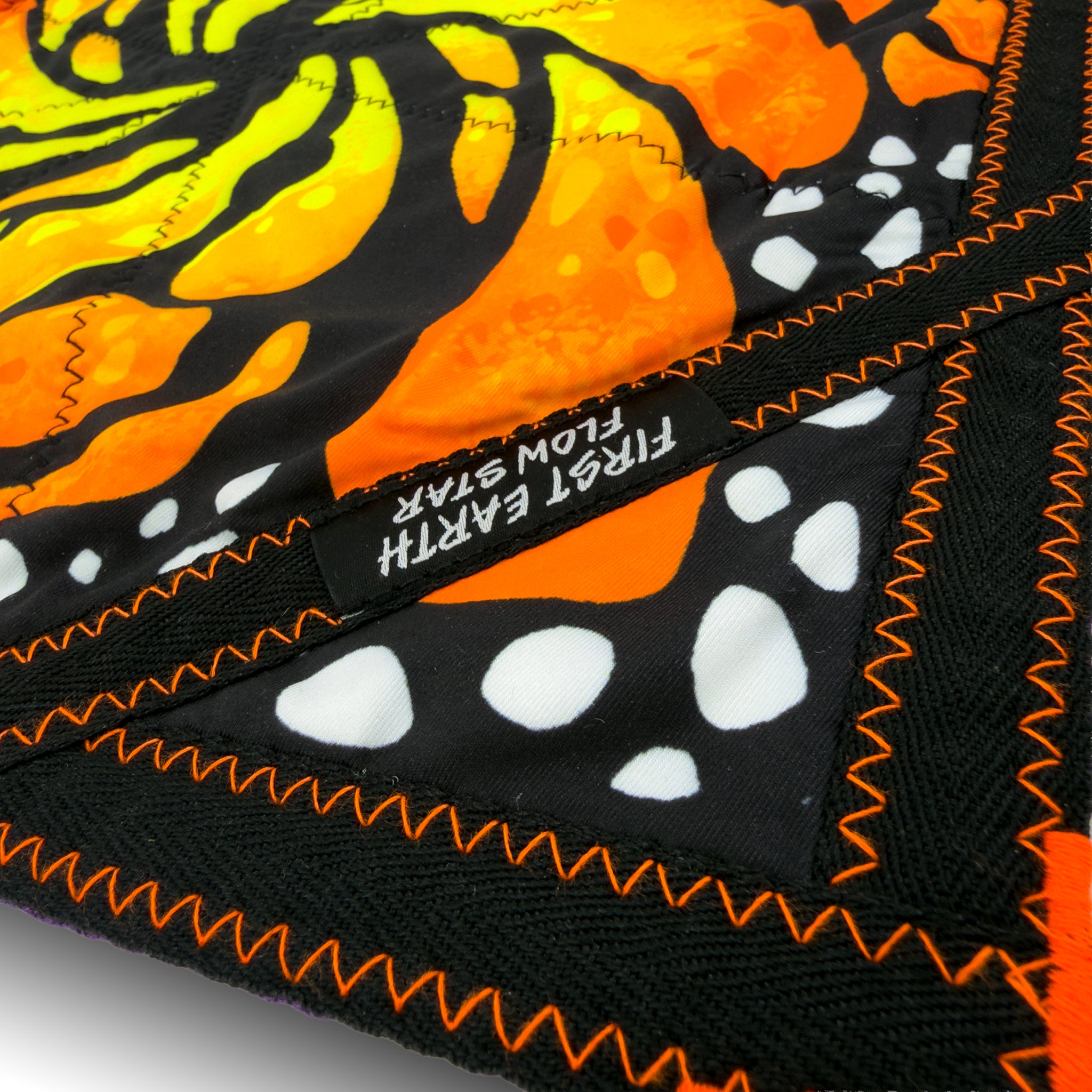 First Earth flow star close up showing durable orange zig zag stitching and fabric detail