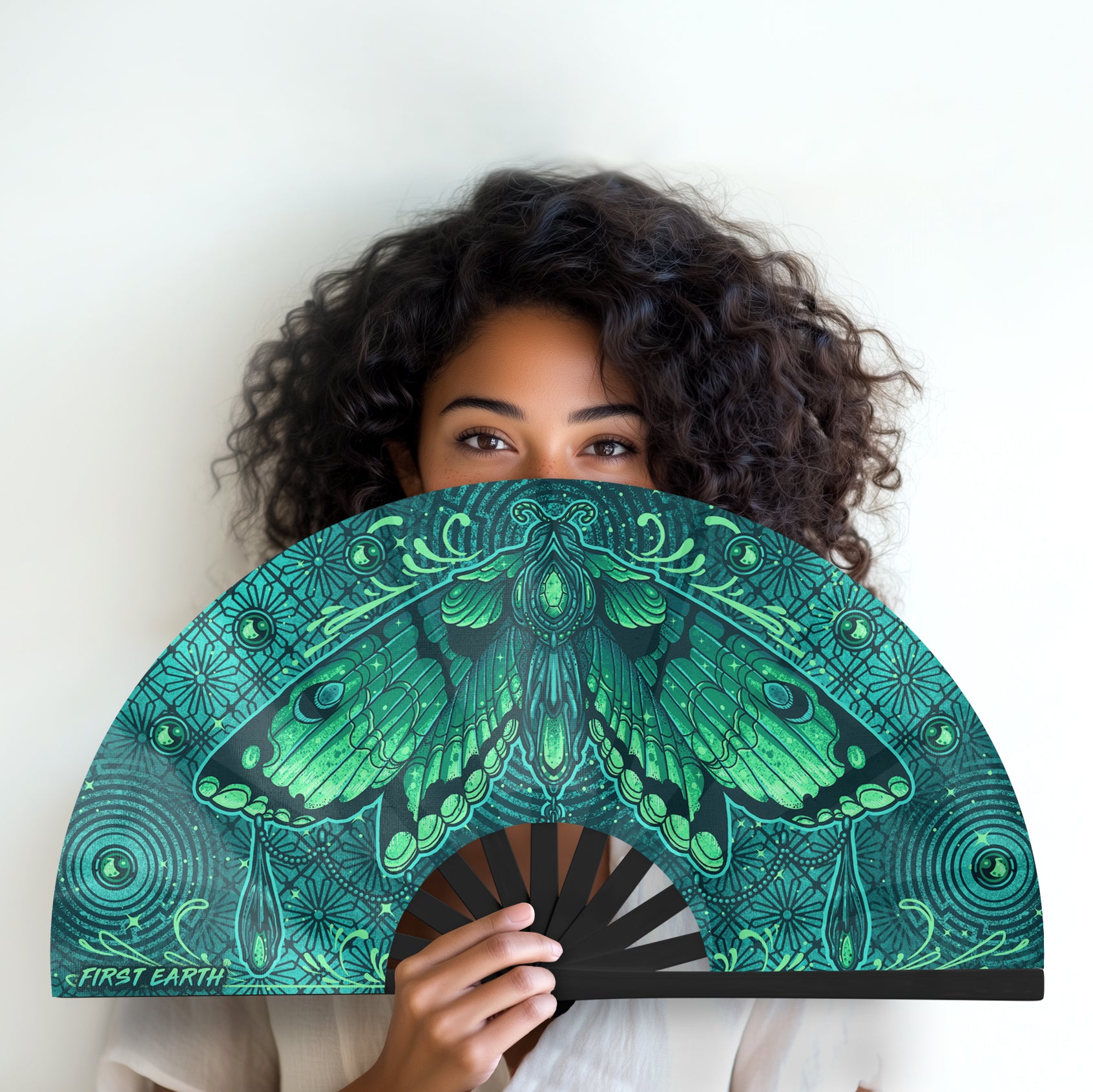 Luna Moth UV glow hand fan by First Earth – collapsible rave accessory with glowing moth design, bamboo ribs, and vibrant polyester fabric for late-night flow