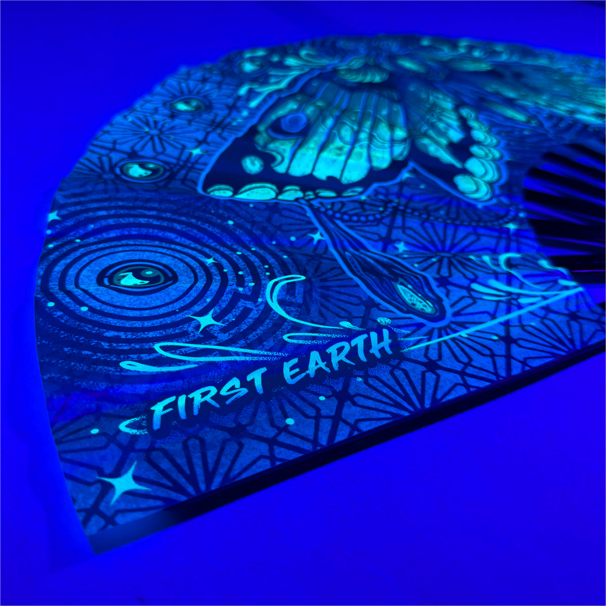 Luna UV-reactive hand fan glowing under blacklight