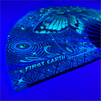 Luna Moth UV glow hand fan by First Earth – collapsible rave accessory with glowing moth design, bamboo ribs, and vibrant polyester fabric for late-night flow
