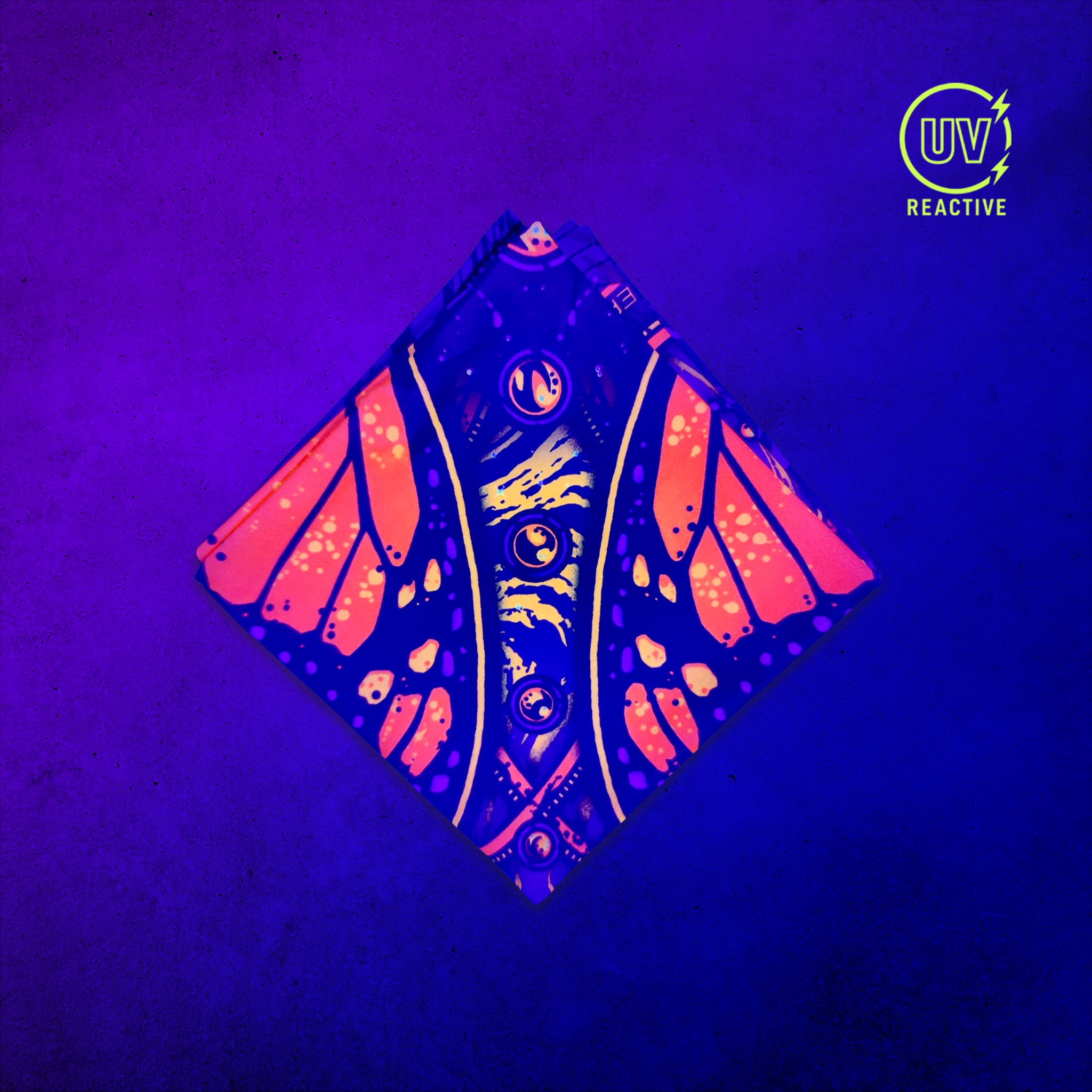 Monarch - UV Glow - Bandana glowing under black light, showing the UV-reactive colors and complete printed design