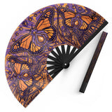 Monarch UV glow hand fan by First Earth – folding rave fan with glowing butterfly design, bamboo ribs, and vibrant polyester fabric that snaps open for a cool breeze 