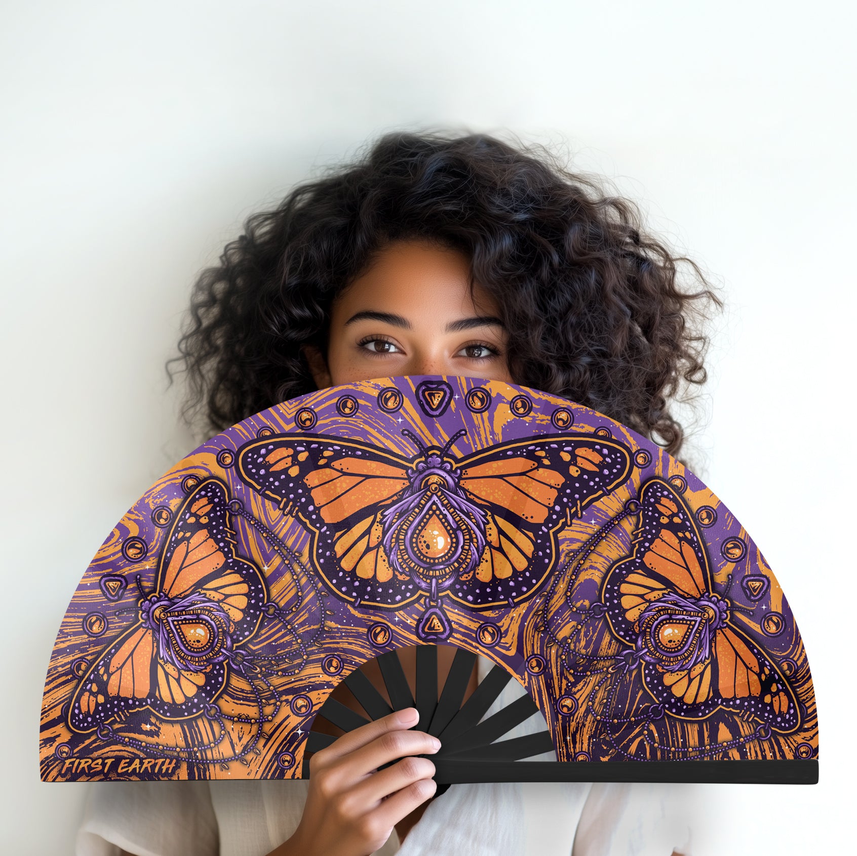 Monarch UV glow hand fan by First Earth – folding rave fan with glowing butterfly design, bamboo ribs, and vibrant polyester fabric that snaps open for a cool breeze 
