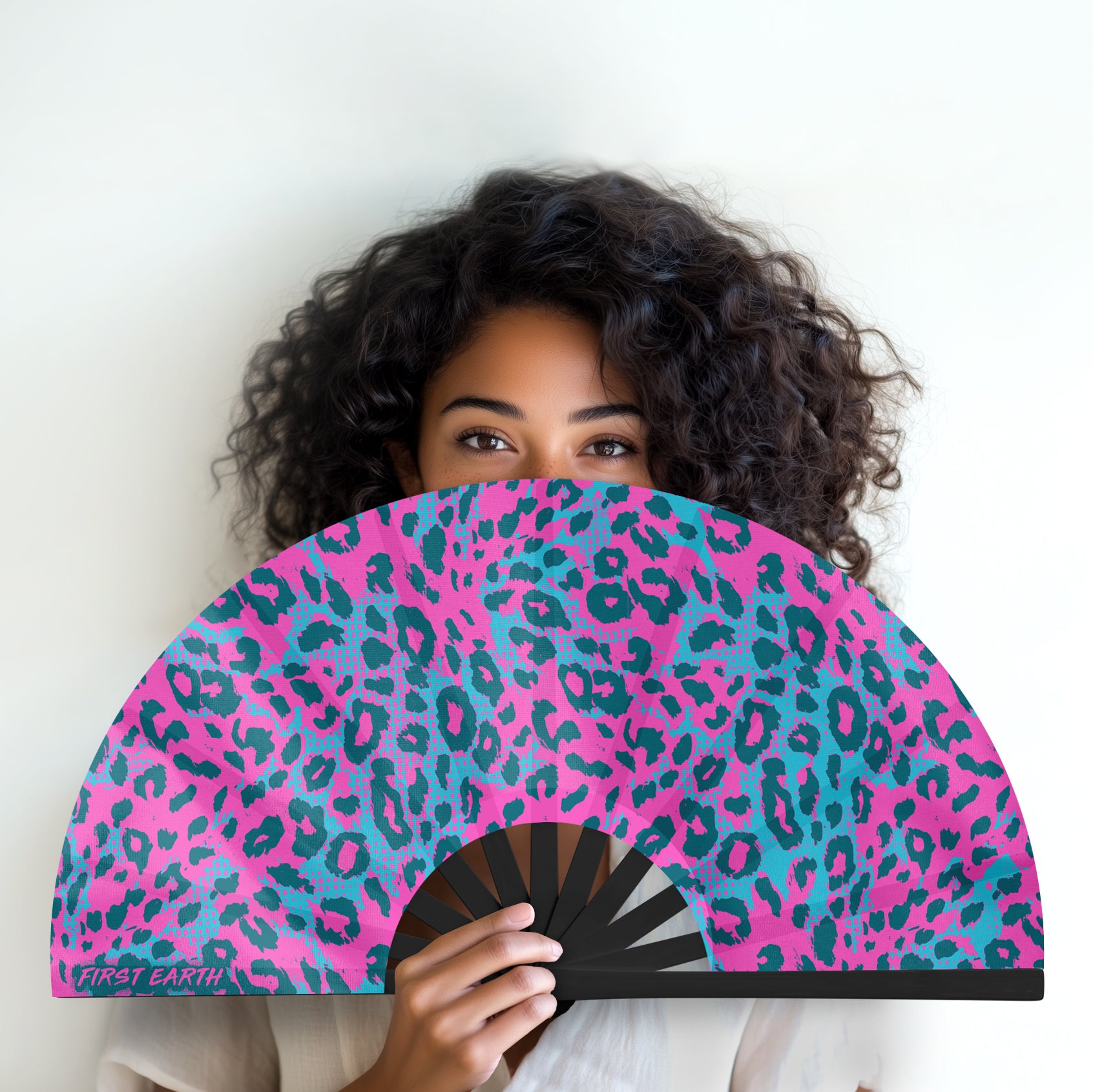 Neon cheetah UV glow folding hand fan designed for raves and music festivals.