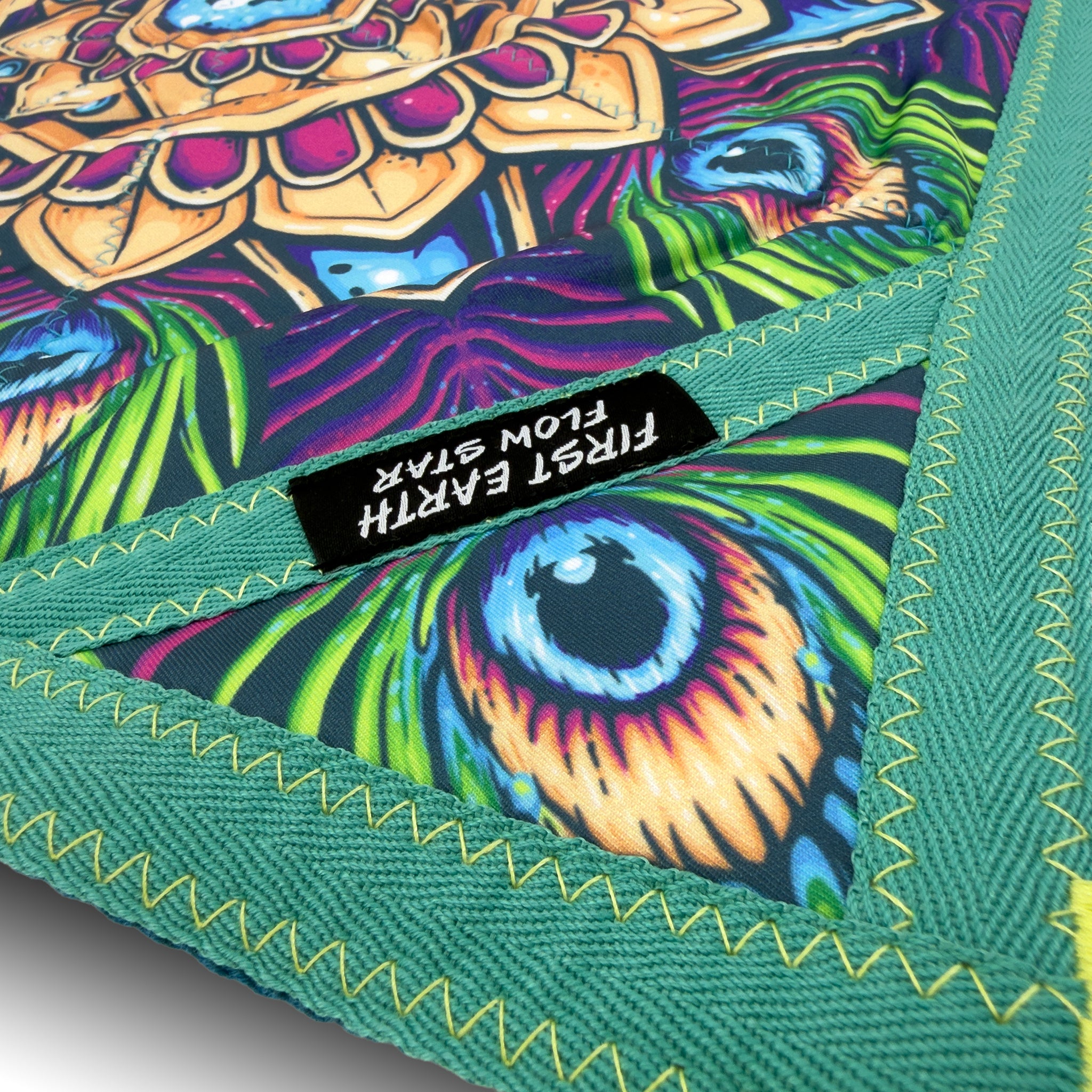 First Earth flow star close up showing peacock artwork, green trim, and durable zig zag stitching