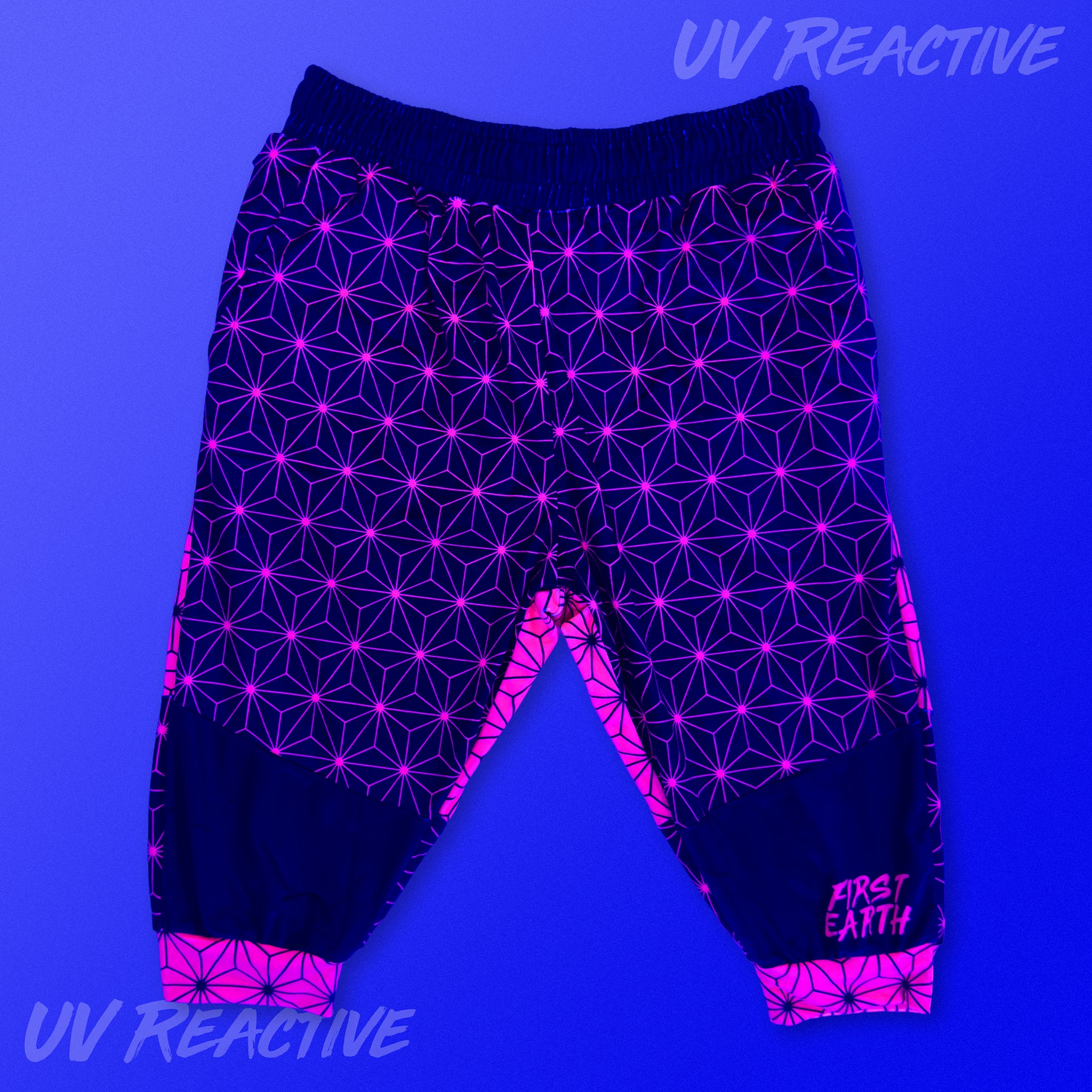 First Earth Asanoha Pink UV velvet 3/4 jogger shorts glowing under UV black light